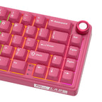 Compact mechanical keyboard with dark keycaps, beige highlights, and a metal volume knob