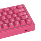Compact mechanical keyboard with dark keycaps, beige highlights, and a metal volume knob