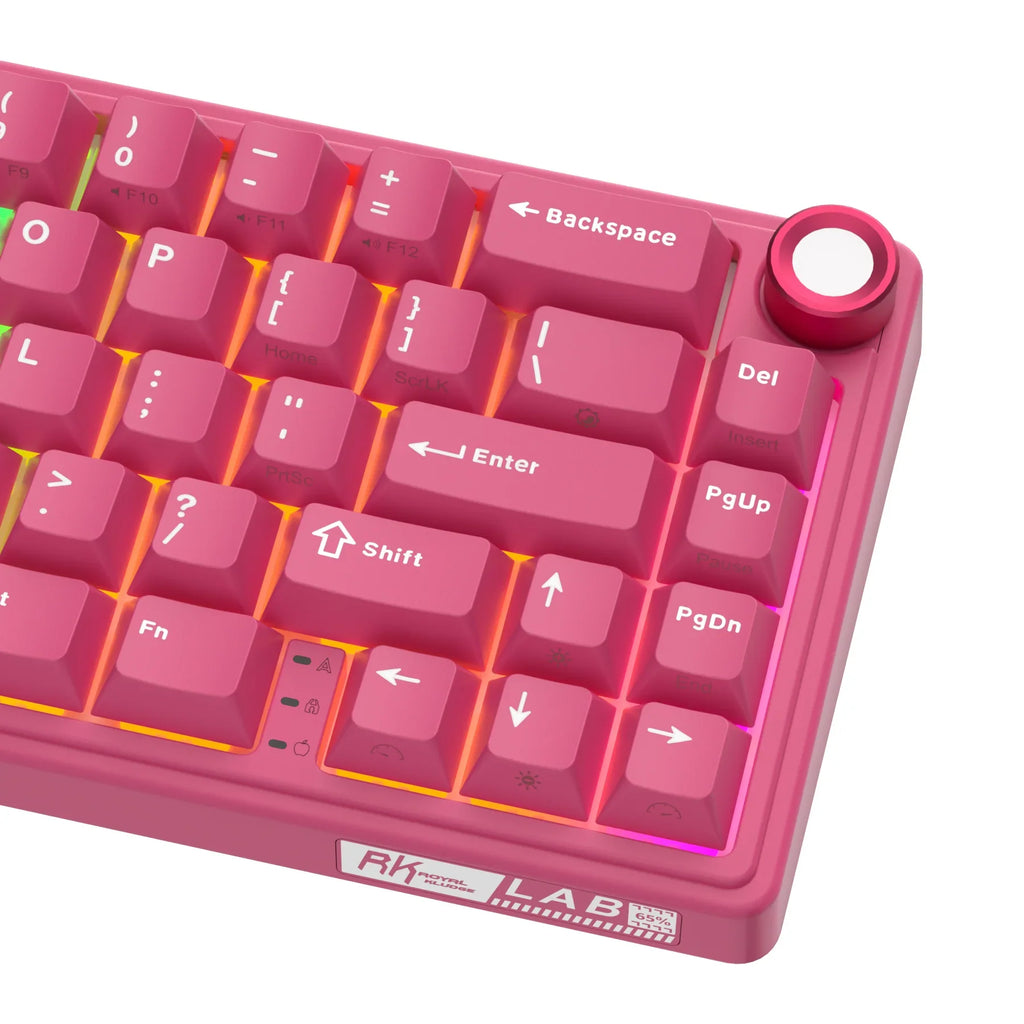Compact mechanical keyboard with dark keycaps, beige highlights, and a metal volume knob