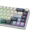 Compact mechanical keyboard with dark keycaps, beige highlights, and a metal volume knob