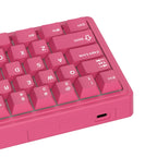 Compact mechanical keyboard with dark keycaps, beige highlights, and a metal volume knob